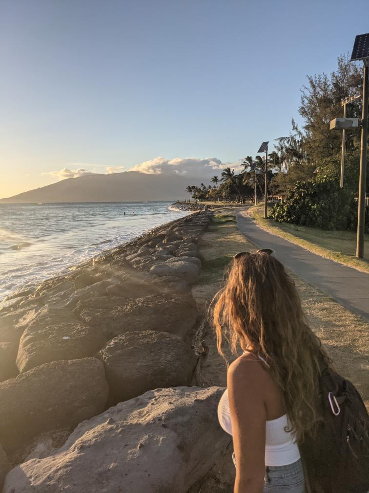 girl looking at the ocean in hawaii