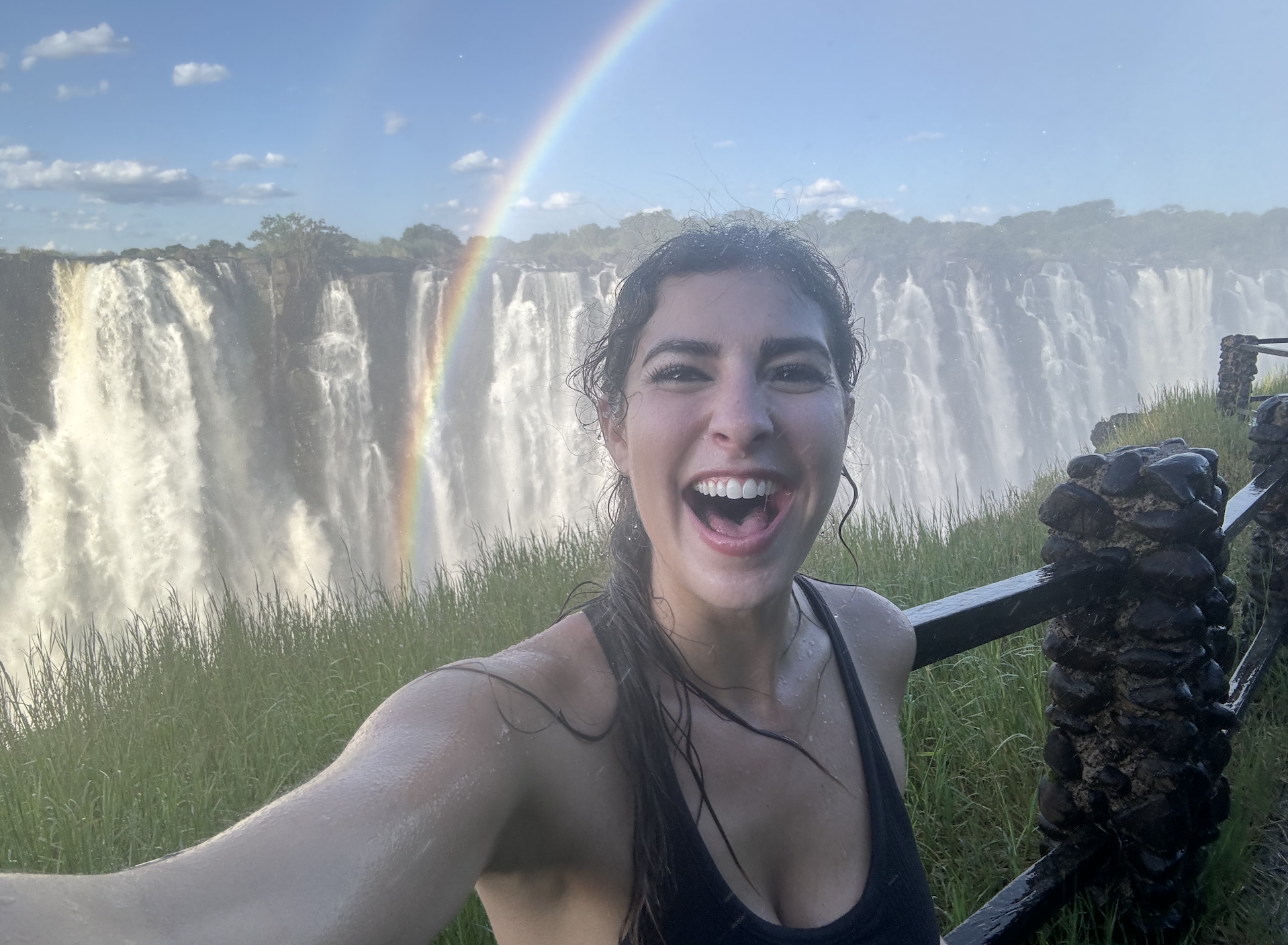 Sophie Mendel on camera in front of Victoria Falls